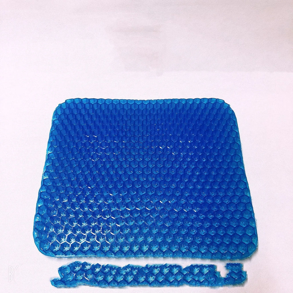 A solid-colour gel seat cushion with a honeycomb pattern, shown on a chair.