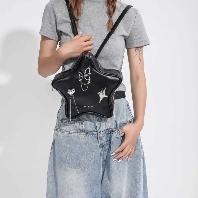 Black PU leather street style backpack with a detachable star-shaped butterfly pendant and chain strap.