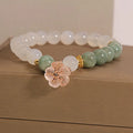 White agate and jade flower bracelet with pink accents on adjustable band