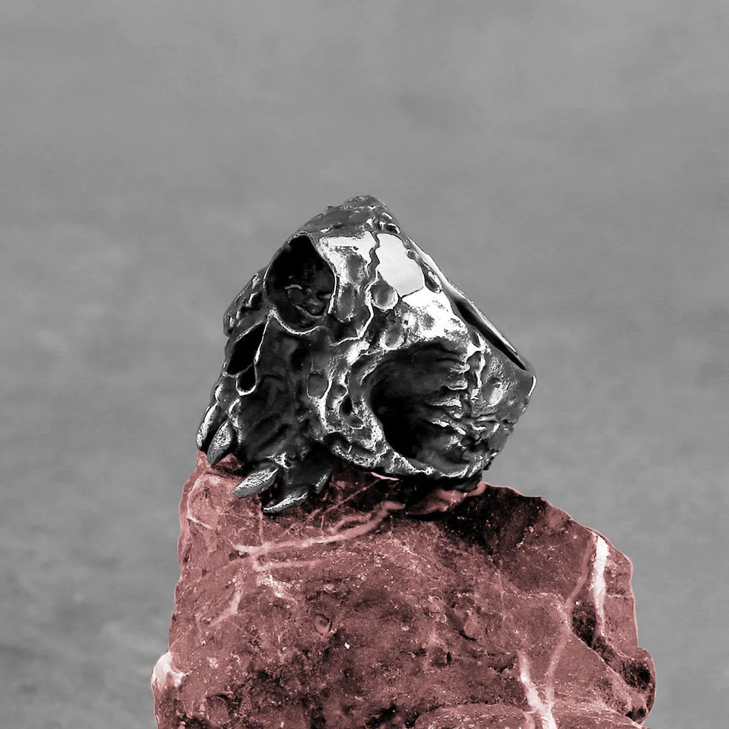 A retro-style alloy ring with a one-eyed skull design, shown in silver tone.
