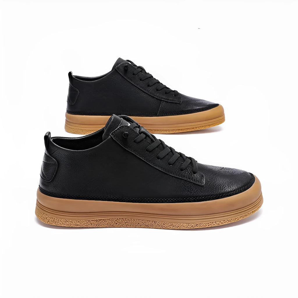 A pair of black men's round-toe casual leather shoes with white laces on a flat rubber sole.