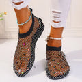 Women's colourful rhinestone and white mesh flat sandals on a rubber sole.