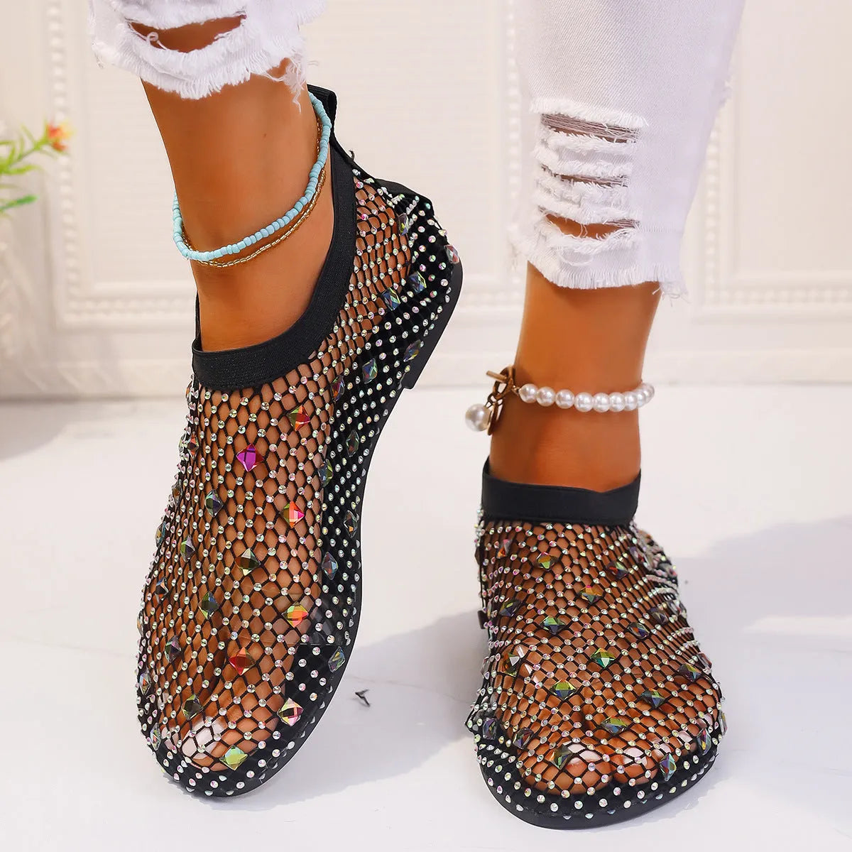 Women's colourful rhinestone and white mesh flat sandals on a rubber sole.
