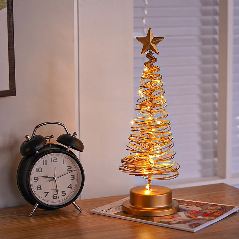 Wrought iron LED Christmas tree light with spiral design and warm white illumination on table
