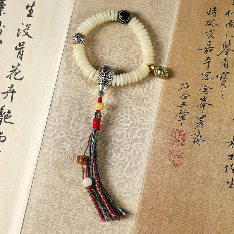 White Bodhi seed Tibetan bracelet showing 3x10mm dimensions in bracelet and handheld styles