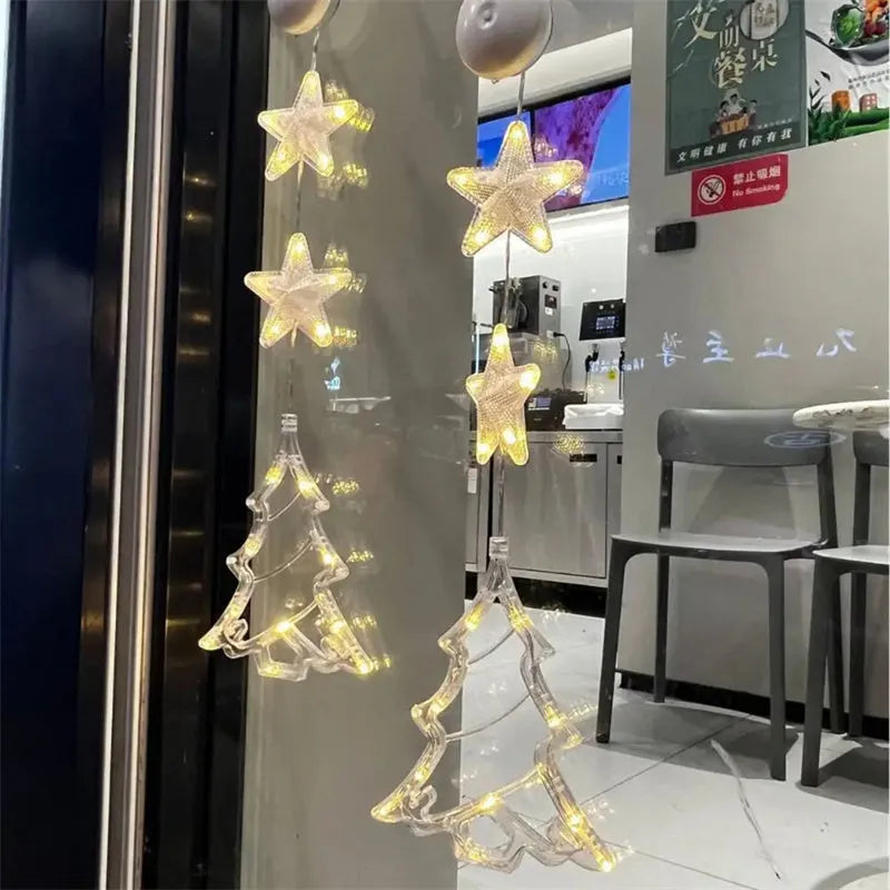 Set of three battery-powered LED Christmas pendant lights with suction cups, showing star, tree, and deer designs.