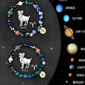 Two natural stone beaded bracelets showing zodiac signs on a table.