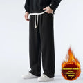 Man wearing apricot coloured double-sided polar fleece winter trousers with a loose fit and drawstring waist.