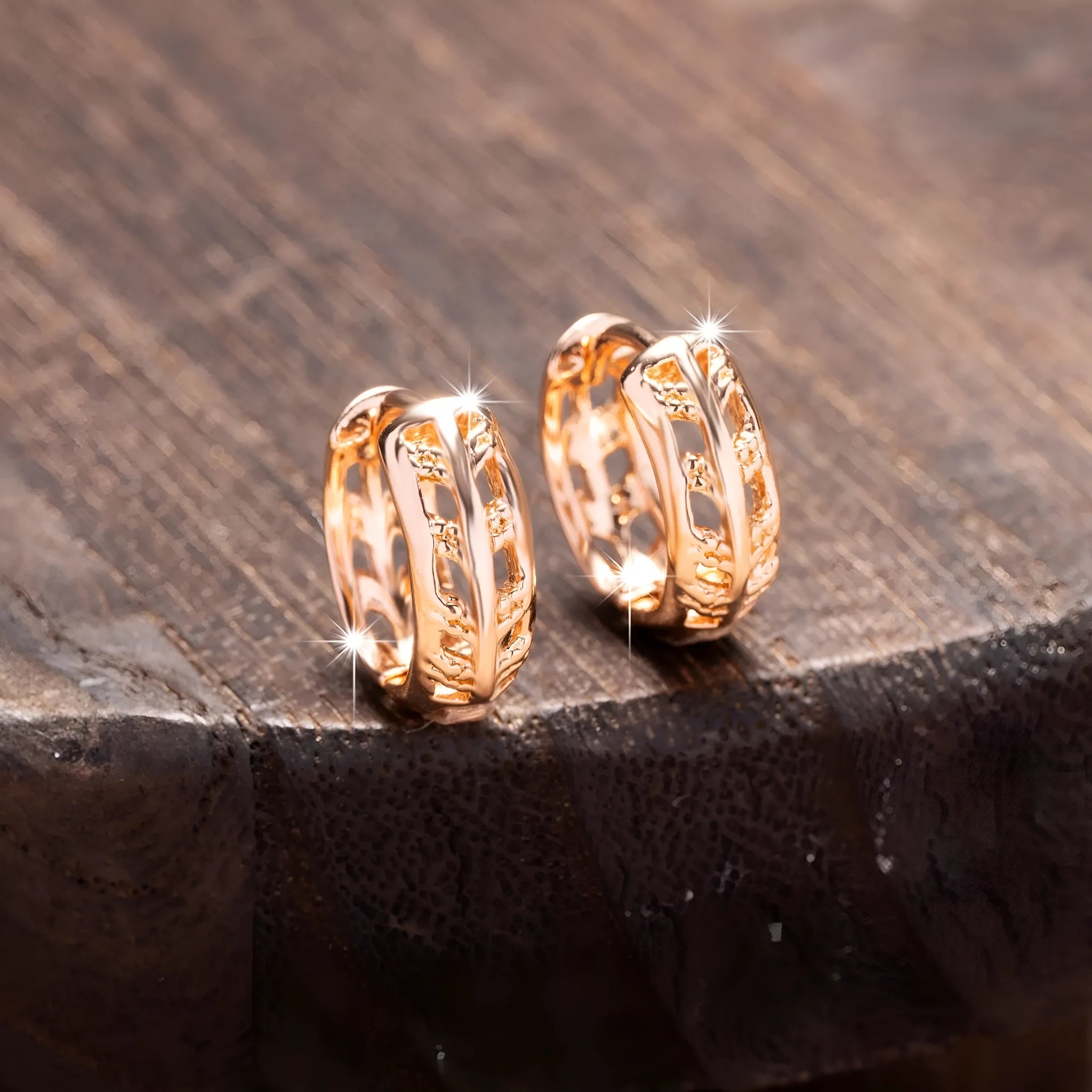 Rose gold coloured copper earrings with hollowed-out leaf and heart shapes.