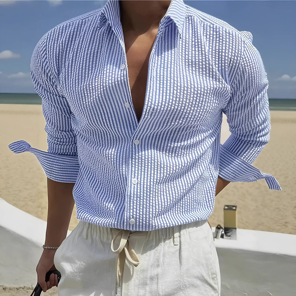 Man's blue and white striped button-up shirt with a lapel collar and long sleeves.