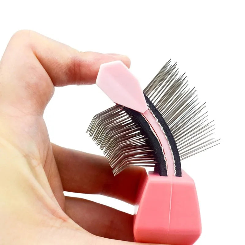 Blue and pink double-sided pet brush with stainless steel pins and ergonomic handle.