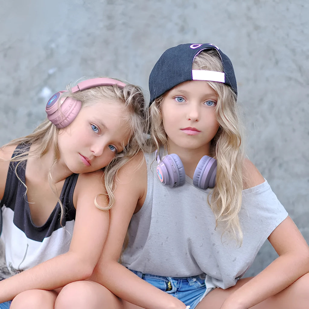 Wireless children's headphones with RGB LED lights in bunny pink colour showing illuminated ear cups