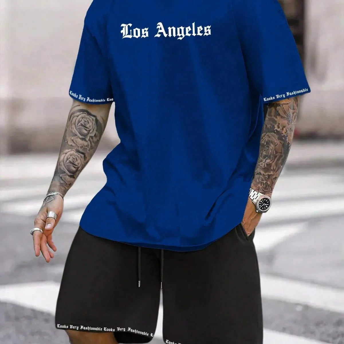 Men's blue printed short sleeve top and matching shorts sports set laid flat
