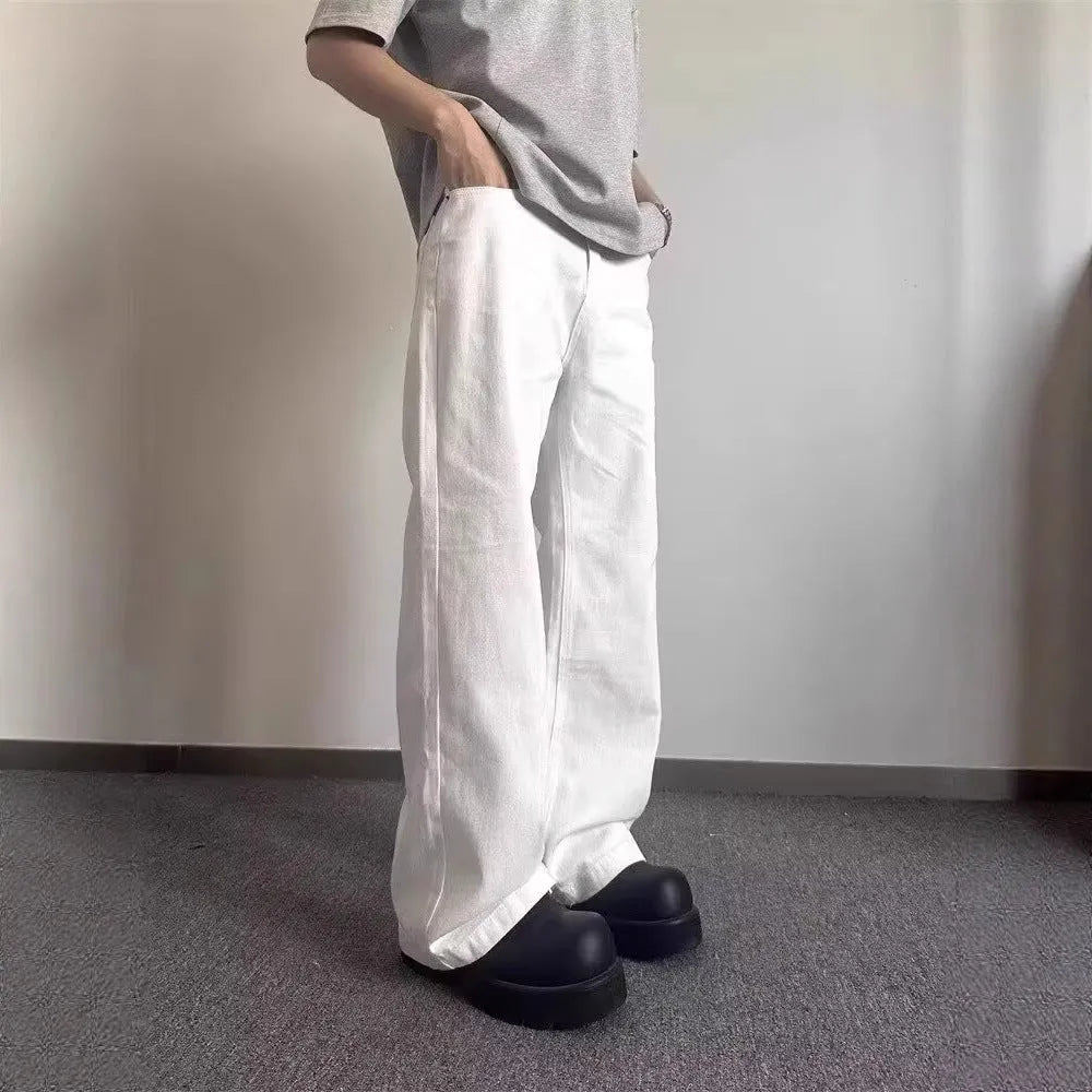 Men's white straight-leg cotton denim jeans on a neutral background.