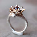 Silver two-tone floral geometric alloy women's ring shown on a white background.