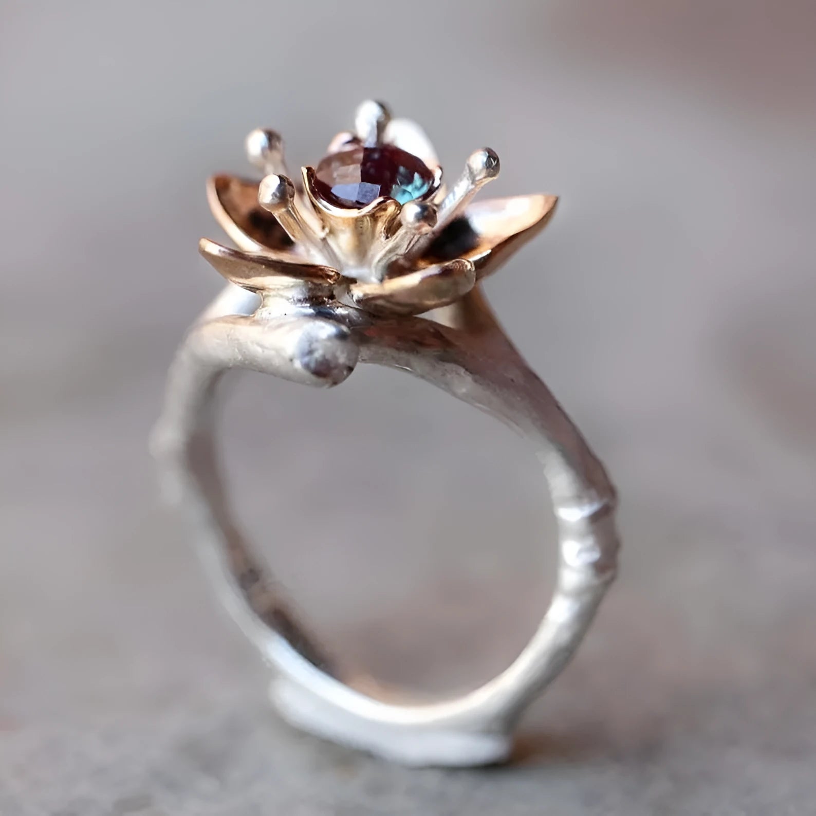Silver two-tone floral geometric alloy women's ring shown on a white background.