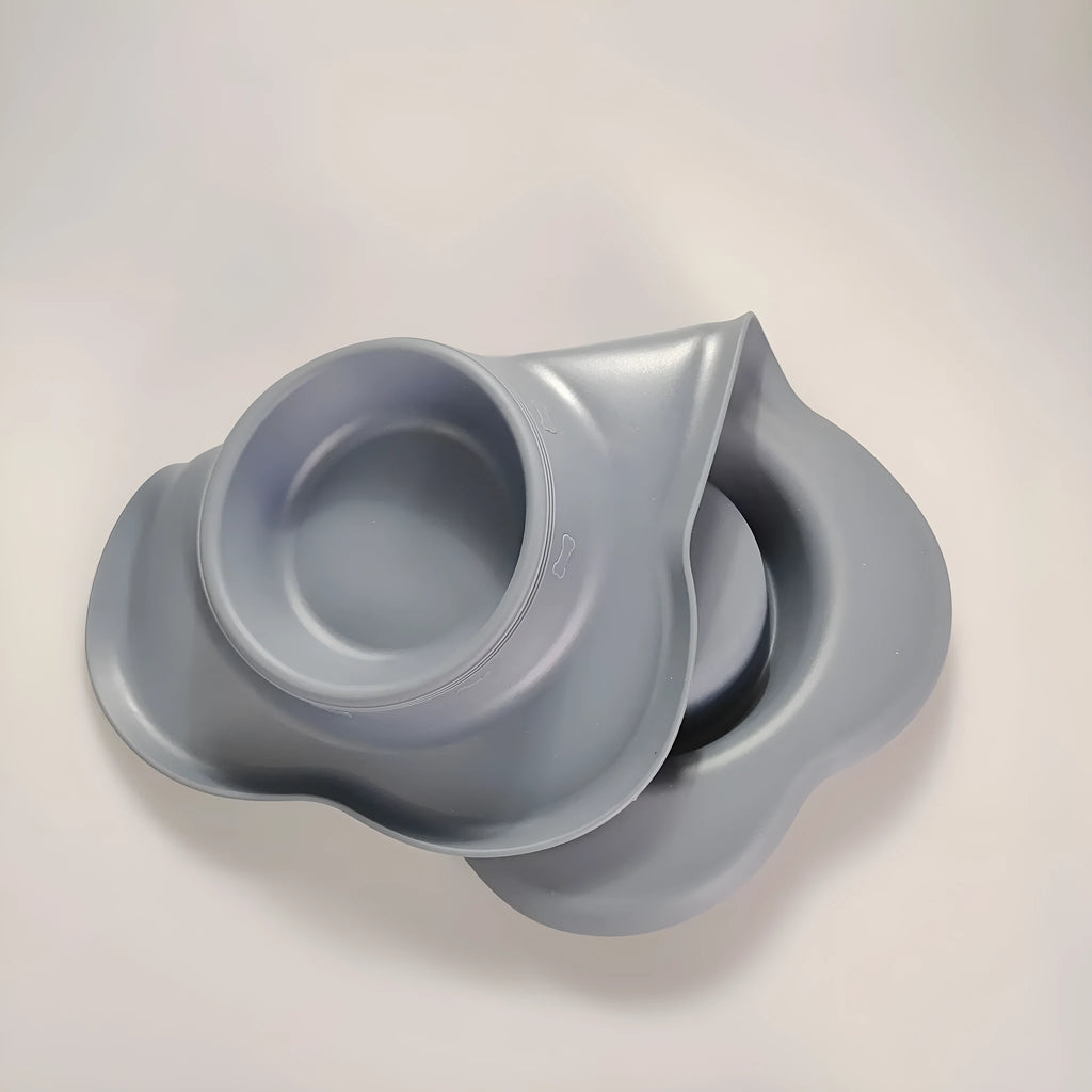 Large silicone pet feeding mat with two bowl slots in blue colour on hard floor