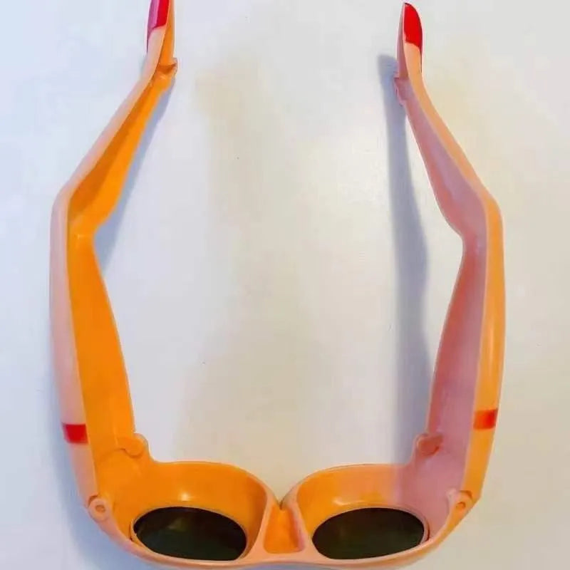 Orange plastic sunglasses with a unique leg and hip personality design.