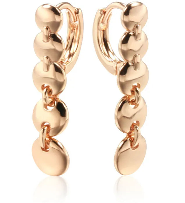 Gold retro long woven copper circle hoop earrings on a white background