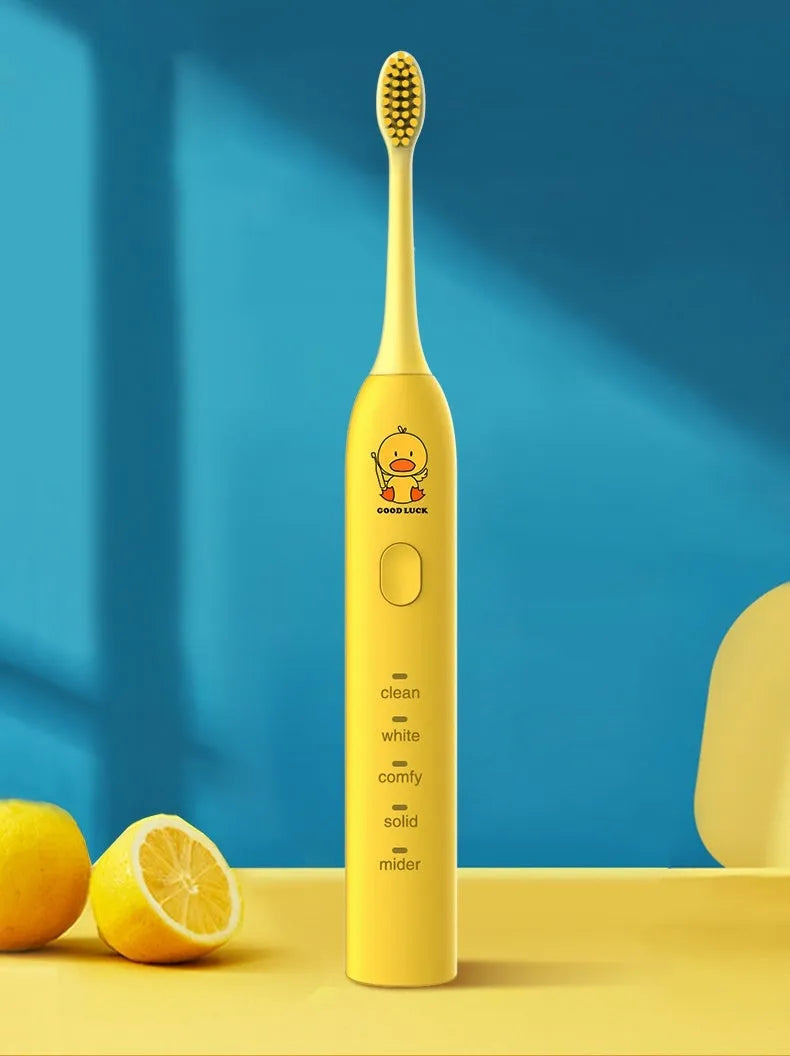Yellow rechargeable electric toothbrush with small duck design, soft bristles, and USB charging port.