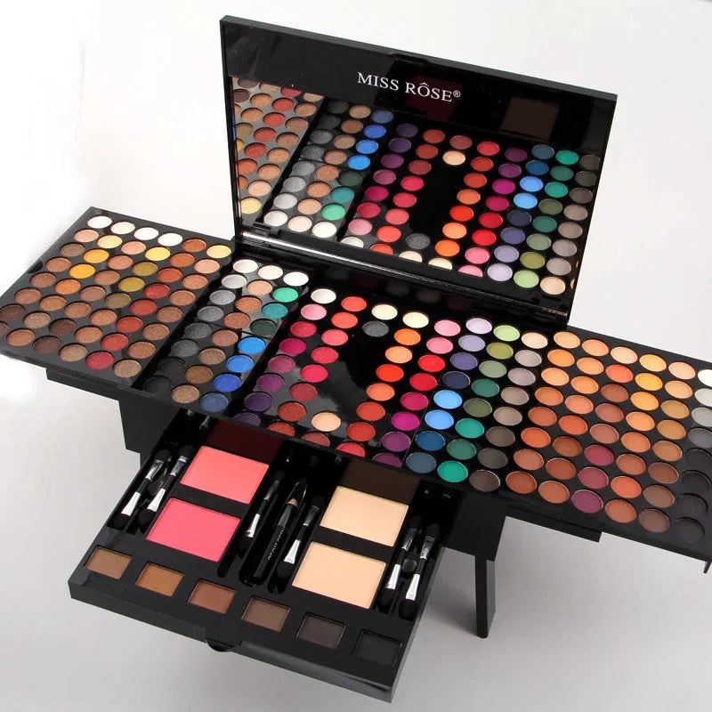 Piano-shaped makeup palette open to show 180 eyeshadow colours with powder and blush pans