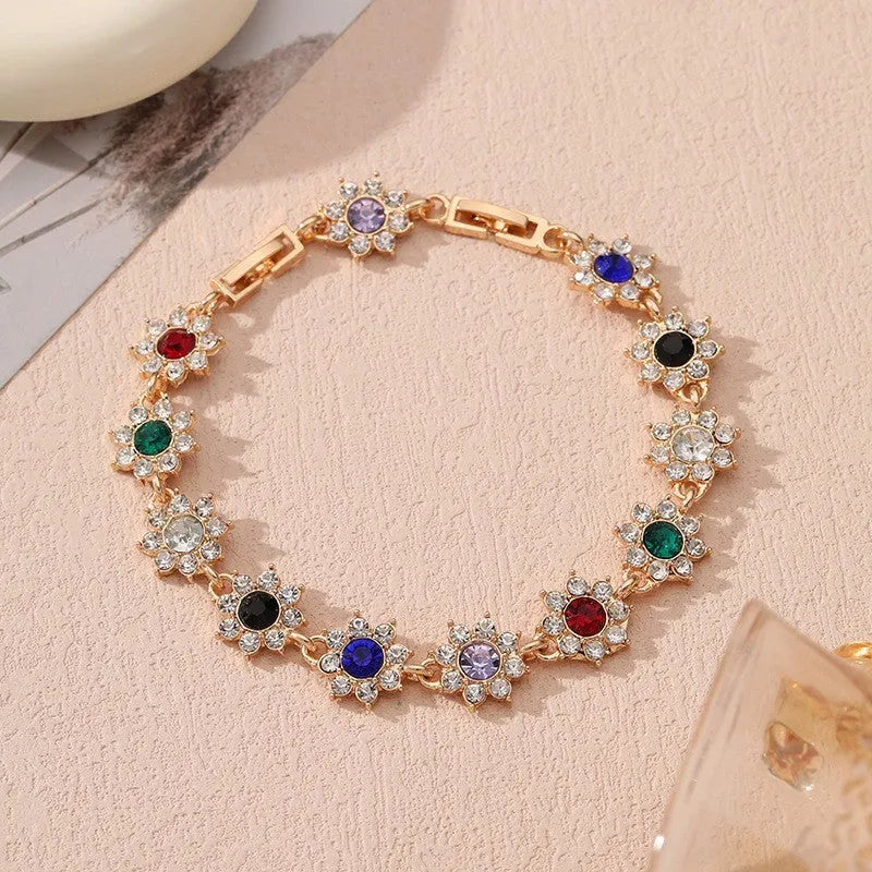 European style electroplated bracelet with flower-shaped coloured gemstones on a metallic chain.