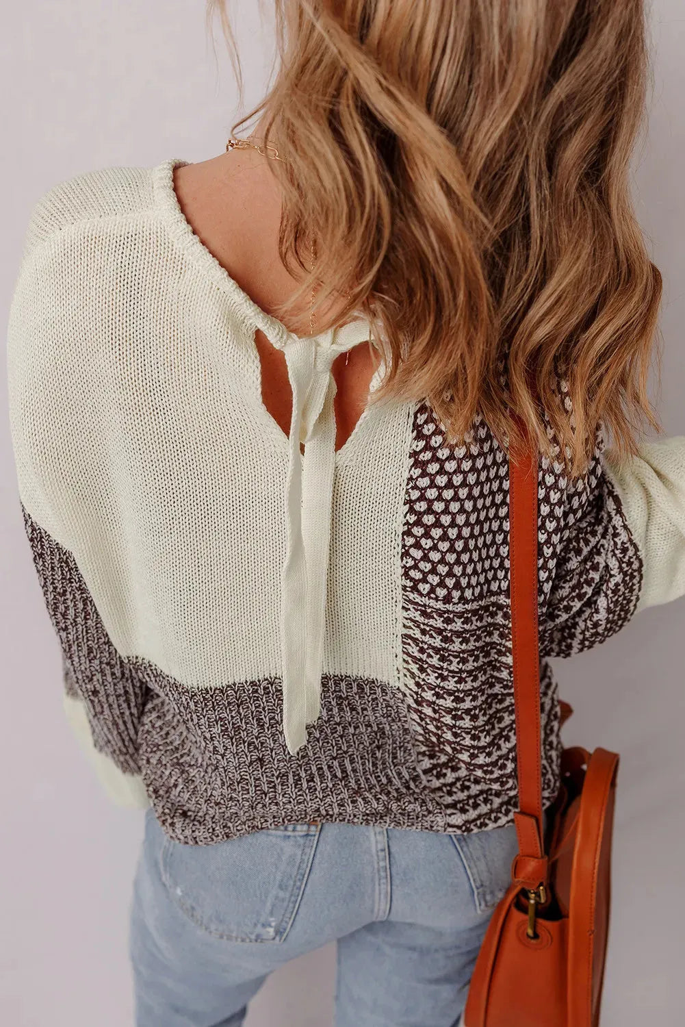 Dark khaki loose sweater with colour block back tie and drop shoulder design.