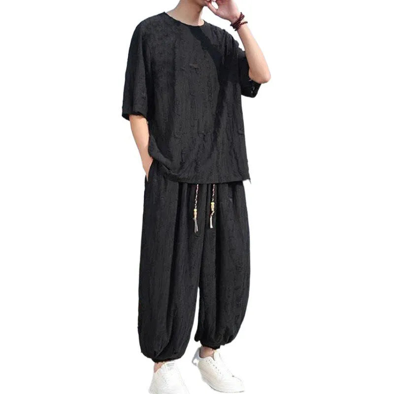 Men's thin knit two-piece set showing short sleeve top and loose cropped trousers in grey.