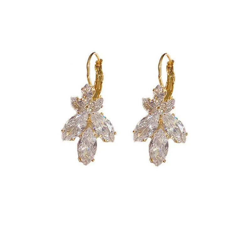 Platinum colour alloy earrings with leaves shape design featuring inlaid zircon stones