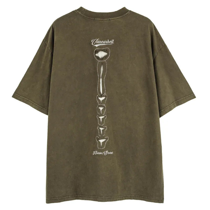 Man modelling a brown loose-fit cotton T-shirt with a printed skull graphic on the front.