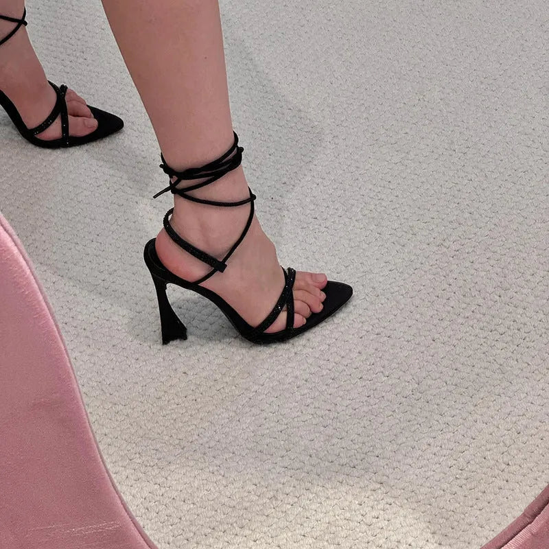 Black satin high heel sandals with 8cm heel and adjustable ankle straps.