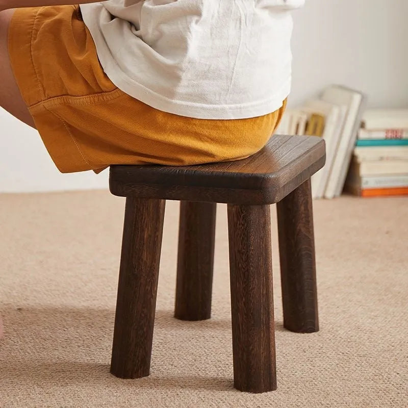 Solid wood household changing stool with distressed finish and bracket structure legs.