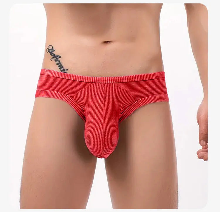 Men's black cotton briefs with a hollow back design and raised 3D pattern on the front.