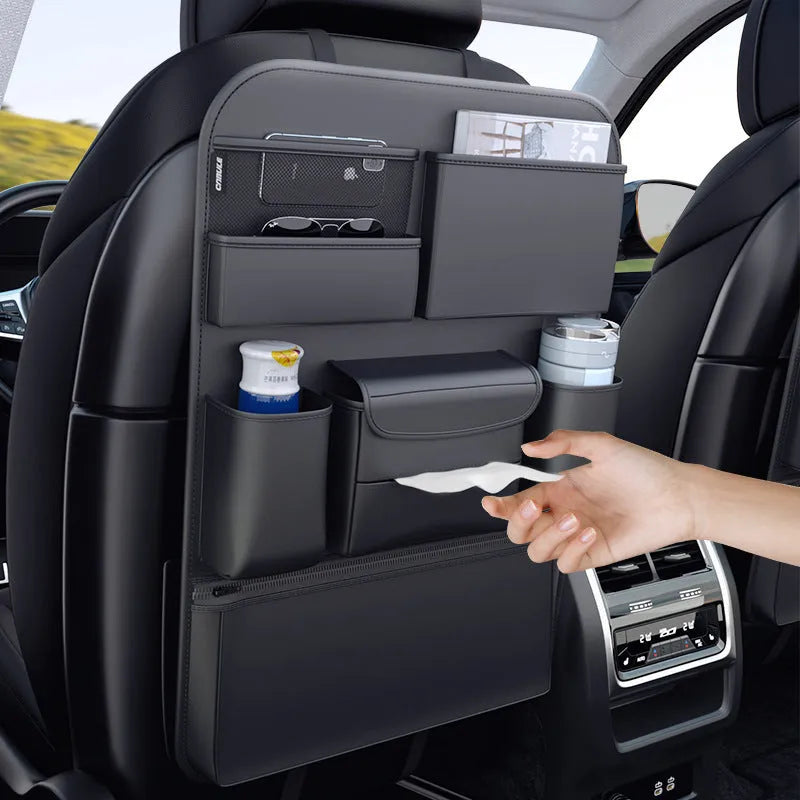Black leather car seat back storage hanging bag with handle shown behind vehicle seat