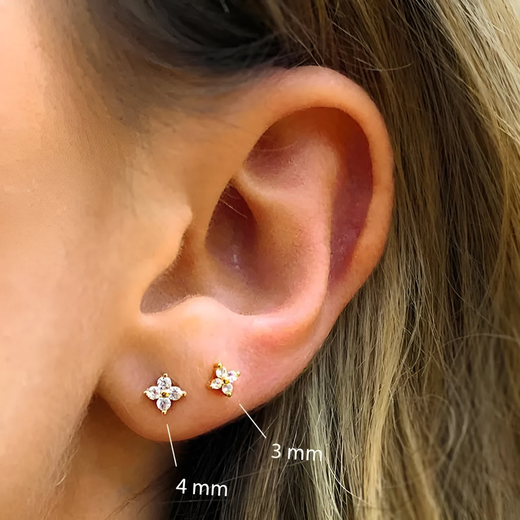 S925 sterling silver petal-shaped stud earrings with crystal flower details in gold and platinum finishes.