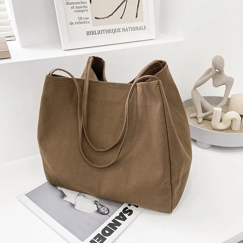 Solid colour women's canvas handbag with double shoulder straps and sandwich pocket design