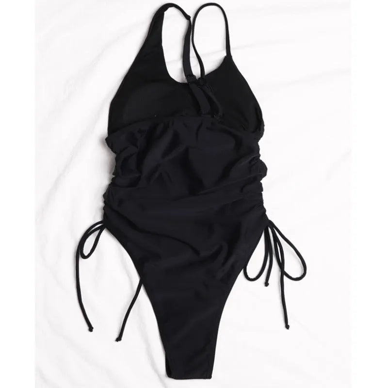 Black sleeveless women's dress with sloping shoulders and lacing detail on a tight fit.