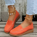 Women's flat PU leather loafers in multiple colours showing round toe and car suture detail.