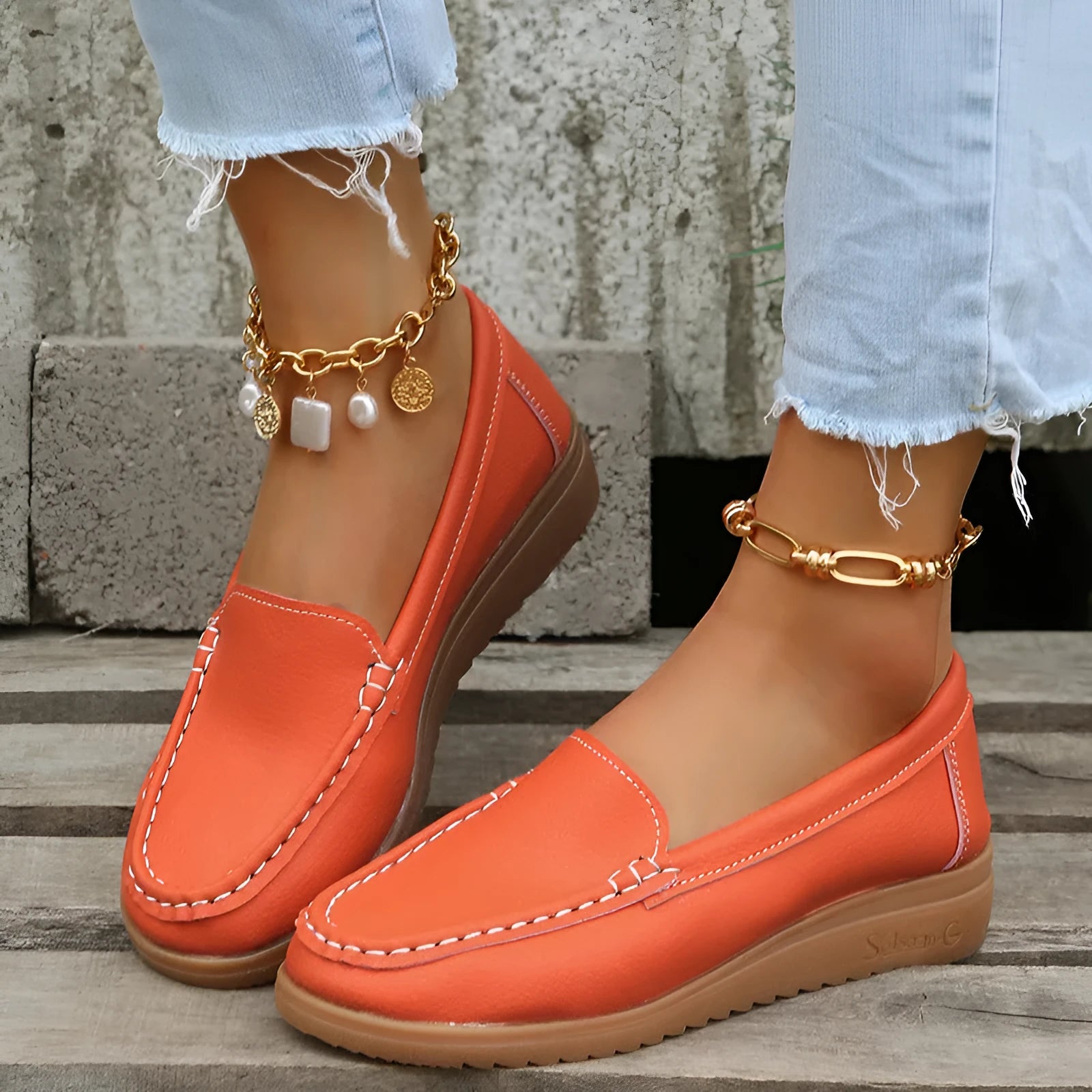 Women's flat PU leather loafers in multiple colours showing round toe and car suture detail.