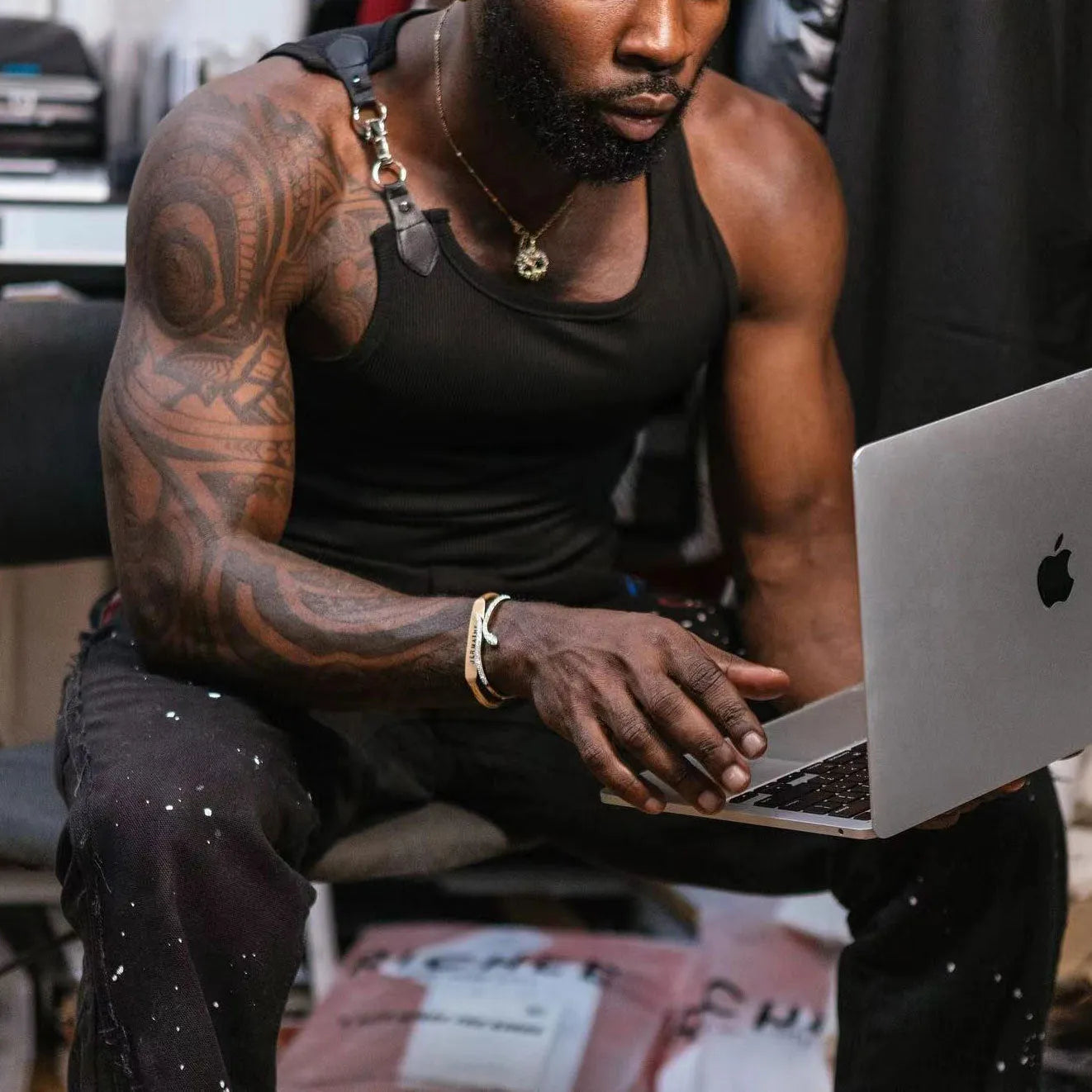 Close-up of a sleeveless tight-fitting vest in black cotton-blend polyester fabric.