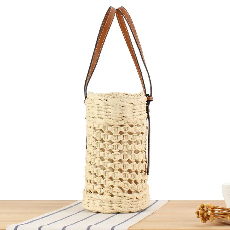 Beige paper-string woven shoulder bag with adjustable strap showing horizontal square design and straw elements