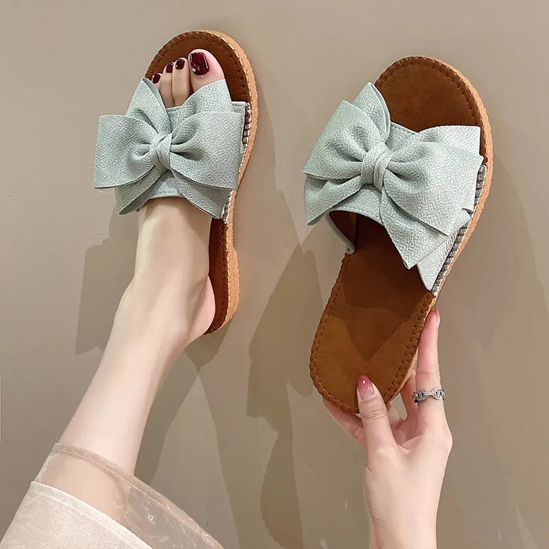 Women's slip-on cloth sandals with suede upper and decorative bow in beige colour