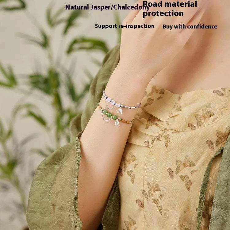 Women's Hetian Jade diamond-shaped bracelet with lotus seedpod design on a woven strap.