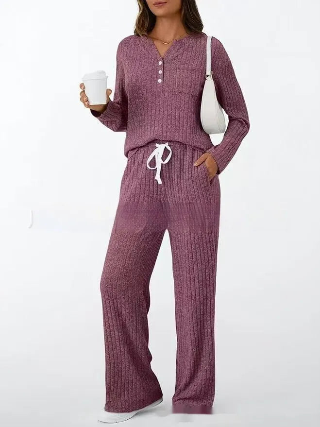 Women's light grey striped knitted long coat with v-neck, long sleeves, and lace-up detail on a mannequin.