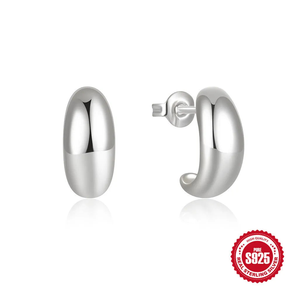A single glossy C-shaped sterling silver stud earring on a white background.