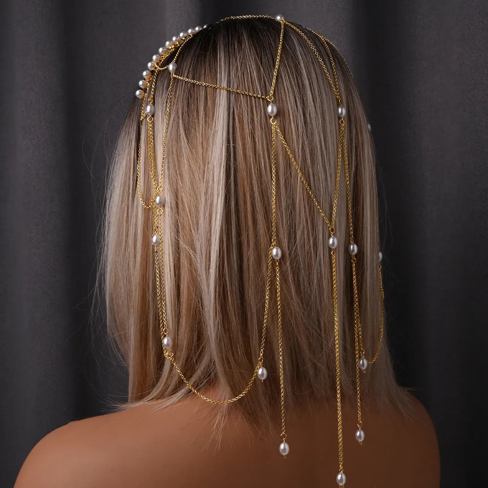 Gold electroplated mesh hair chain for women with pearl beads and a dangling tassel detail.