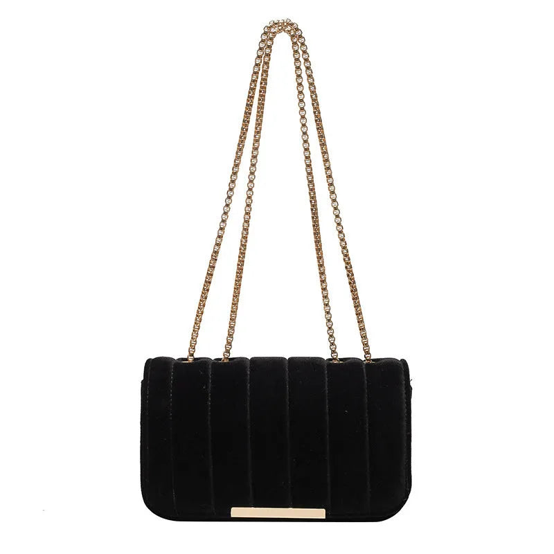 One shoulder velvet chain crossbody bag in solid colour, small square shape with gold chain strap, on white background.