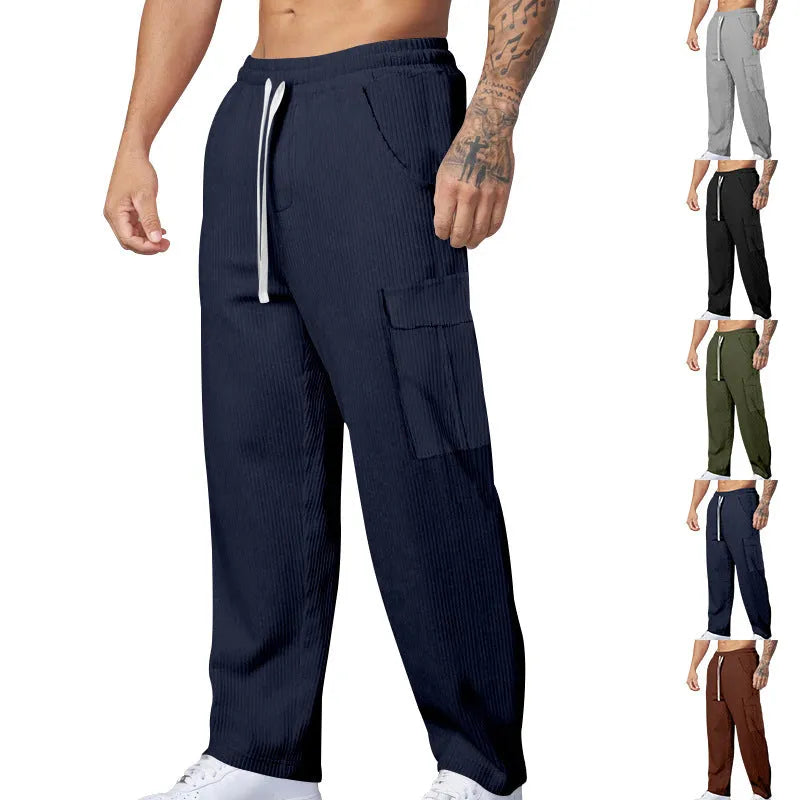 Men's navy blue corduroy cargo trousers with a straight loose leg and a drawstring waist, laid flat.