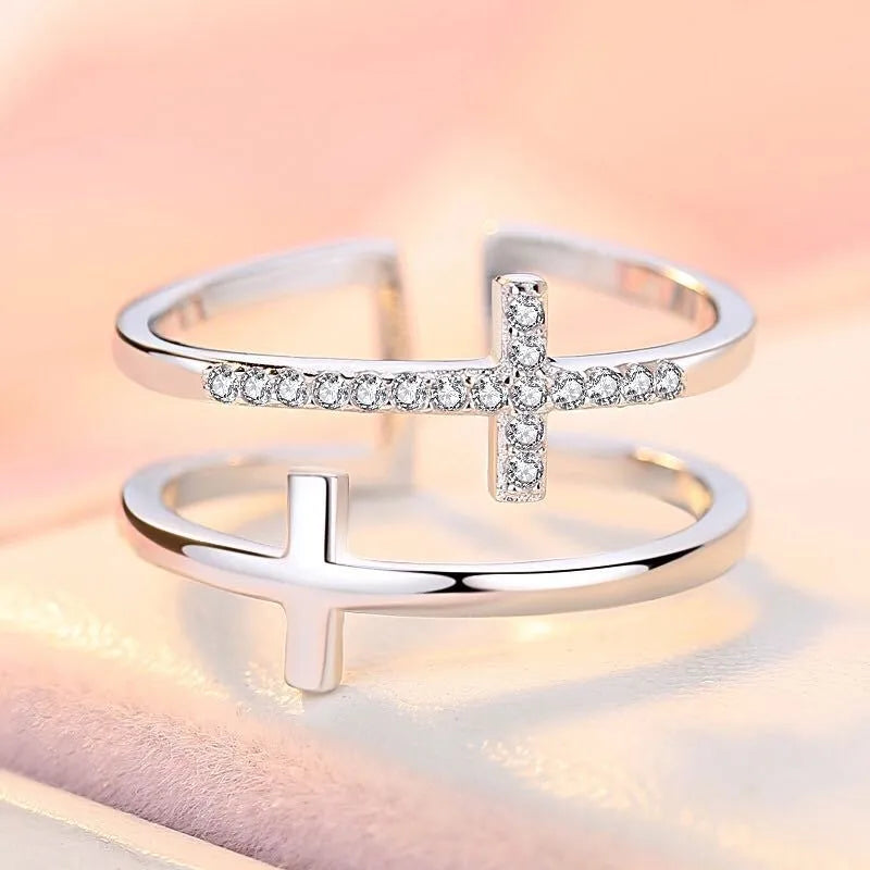 Women's adjustable copper ring featuring a miniature double cross design with sterling silver and zircon inlay.