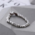 Handmade wooden women's bracelet with silver-coloured irregular square design on elastic band